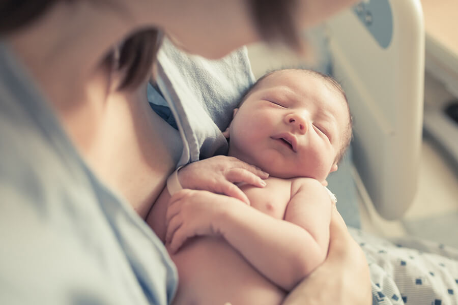 mother holding new born child