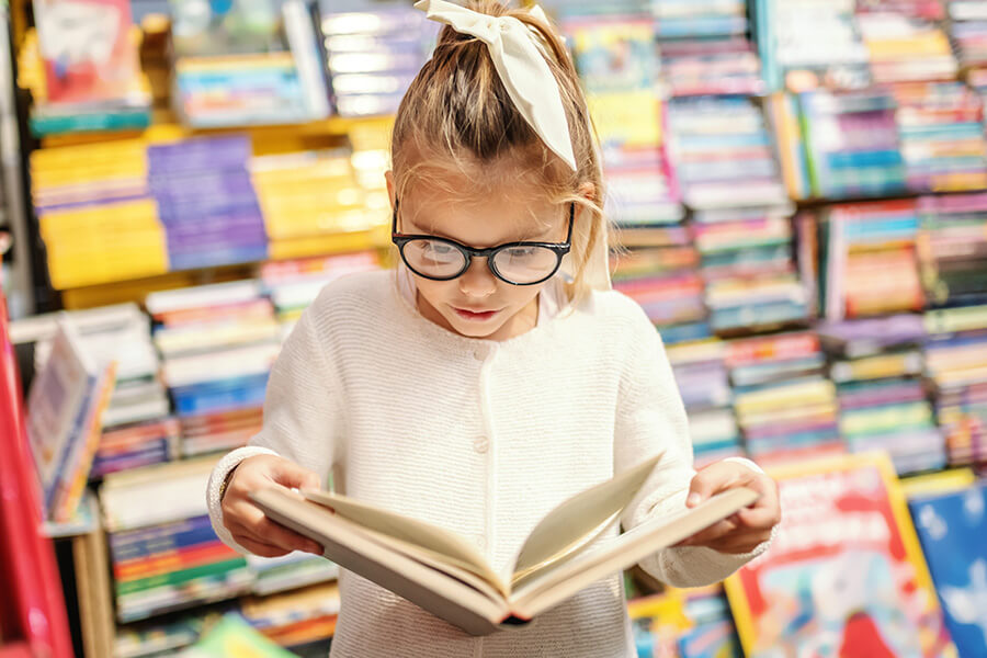 girl in library reading